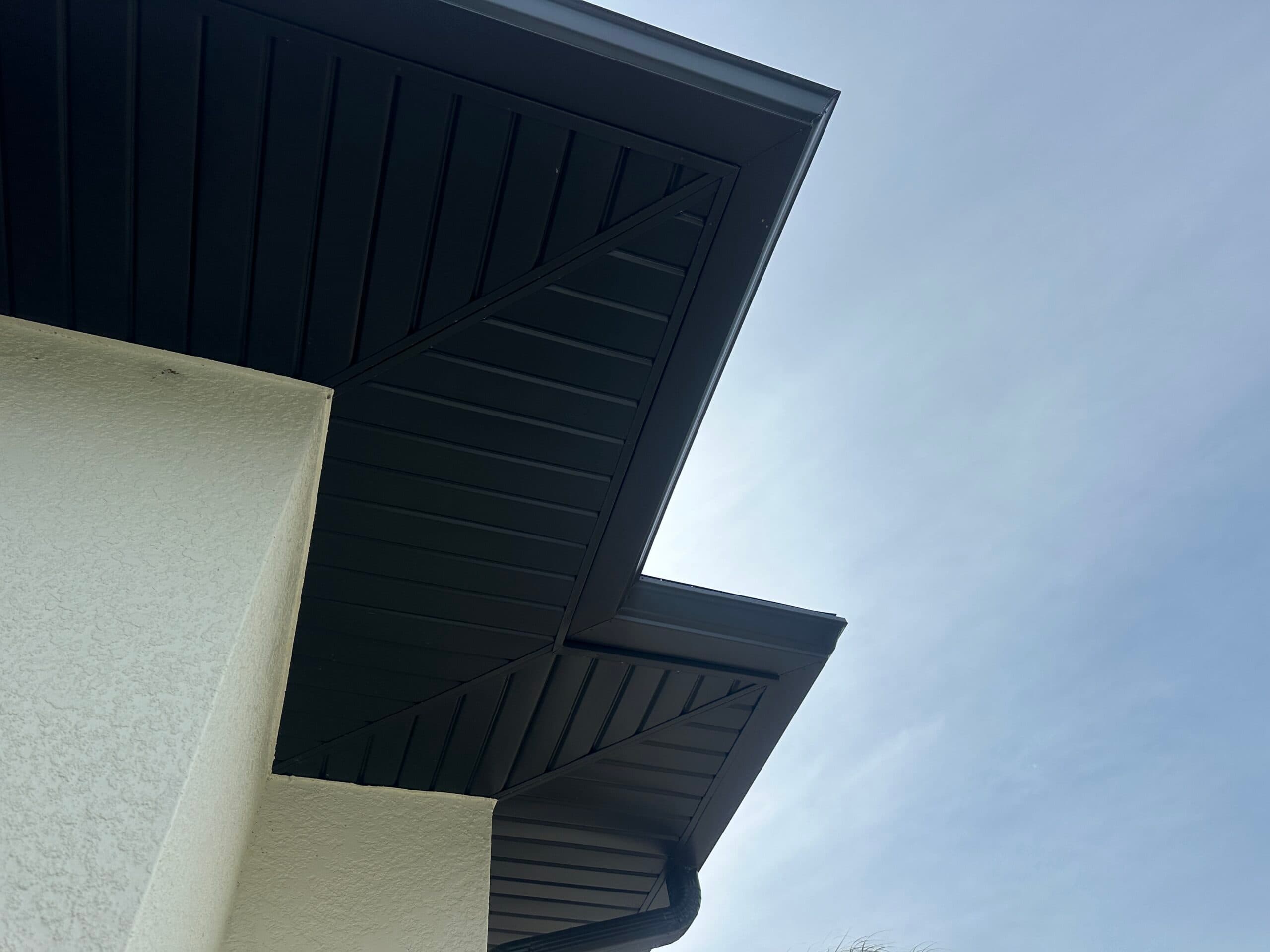 Gutter installation on multi-story home with complex roofline in Englewood FL